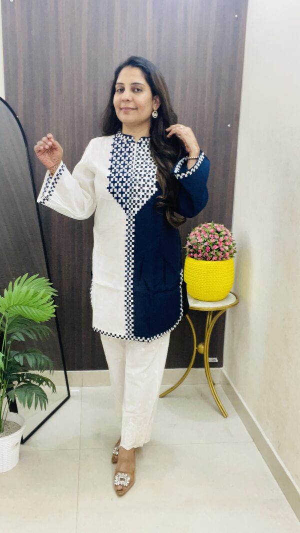 Stylish white and blue long kurta set with contrast detailing.